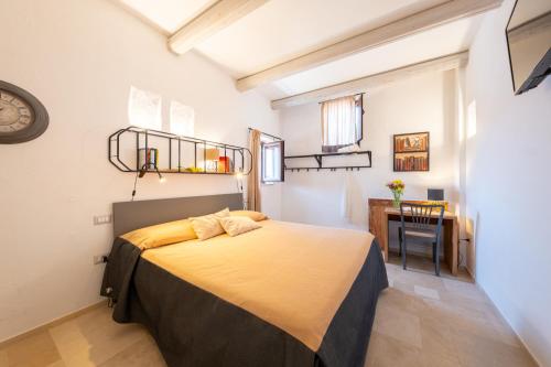 sypialnia z łóżkiem i biurkiem w pokoju w obiekcie HelloApulia Masseria Don Sisto w Alberobello