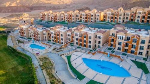 an aerial view of a resort with swimming pools at شاليه في بورتو السخنه منتجع Chalet Porto el sokhna Heaven hills عائلات فقط H in Ain Sokhna