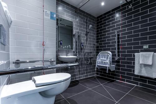 a black and white bathroom with a toilet and a sink at Holiday Inn Express - Exeter - City Centre, an IHG Hotel in Exeter