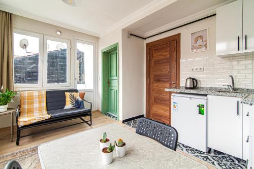 eine Küche und ein Wohnzimmer mit einem Tisch und einem Sofa in der Unterkunft Chic Apartment in Balat, Fatih with Balcony in Istanbul