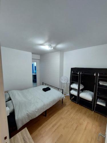 a bedroom with a bed and a wooden floor at Appartement Le Suly in Salins-les-Bains