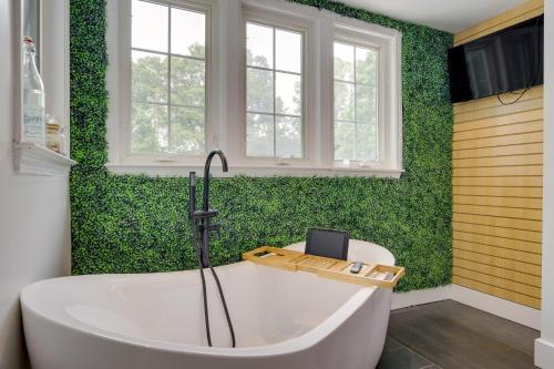 a bath tub in a bathroom with green walls at Spacious Durham Home with Fire Pit and Hot Tub! in Durham