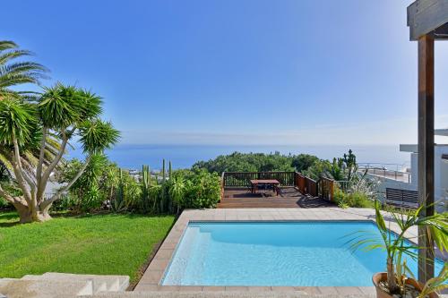 a swimming pool with a view of the ocean at Camps Bay Villa Views Pool Garden in Cape Town
