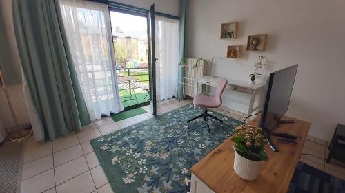 a living room with a desk and a chair at LLN lodge in Louvain-la-Neuve