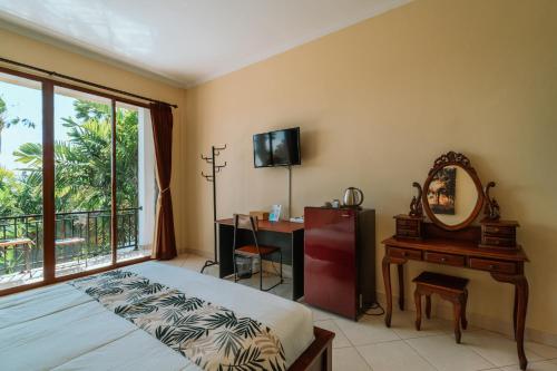 a bedroom with a bed and a desk and a mirror at Umah Kita in Seminyak