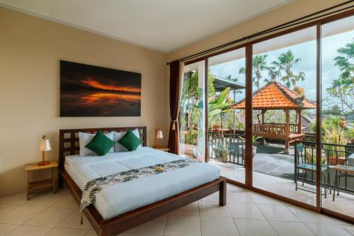 a bedroom with a bed and a large window at Umah Kita in Seminyak