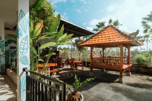 a gazebo with chairs and tables in a patio at Umah Kita in Seminyak