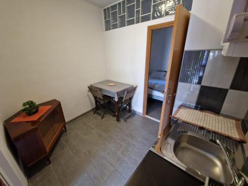 a small bathroom with a sink and a table at Simba in Biograd na Moru