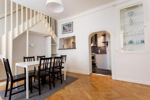 a kitchen and dining room with a table and chairs at ApartDirect Gamla Stan III in Stockholm