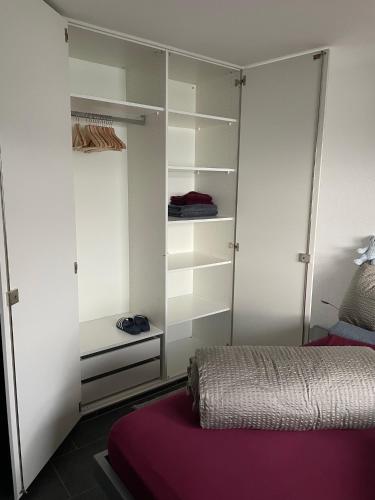 a bedroom with a bed and a closet at Villa Bootsmann mit spektakulärer Seesicht nahe Badestrand in Vitznau