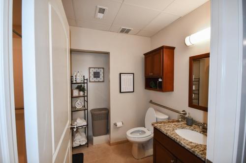 a bathroom with a toilet and a sink at Stay at the Historic Inman in Champaign