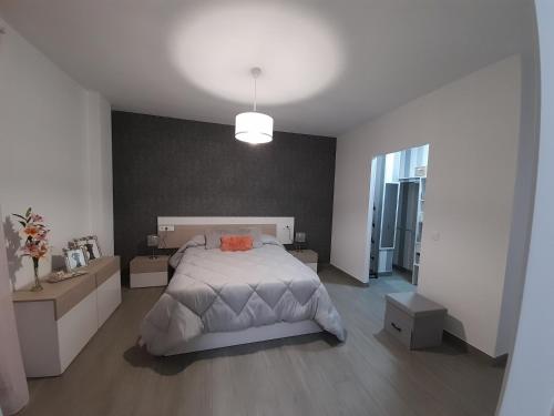 1 dormitorio con 1 cama grande y pasillo en Puerta de la Bética, en Mengíbar
