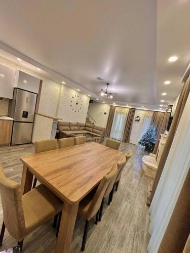 a dining room with a wooden table and chairs at Wonder Hill group in Bakuriani
