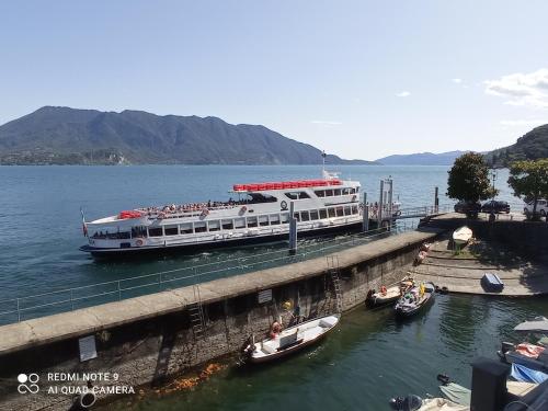 a large boat is docked at a dock on the water at Il Vapore in Oggebbio