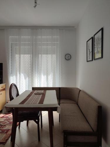 a living room with a couch and a table at MILA city center-free parking in Vranje