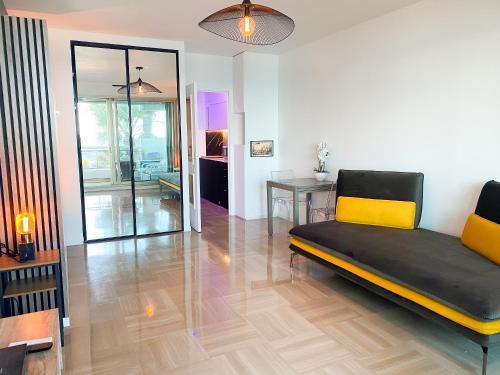 a living room with a couch and a table at Promenade-des-anglais-front-sea in Nice