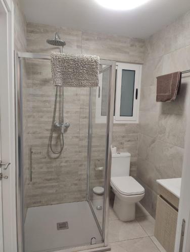 a bathroom with a shower and a toilet at Gżira, 2 bedroom apartment in Il-Gżira