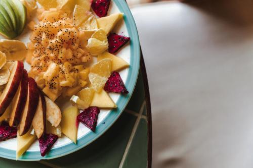 a blue plate of fruit on a table at Mellow Resort in Gemastepe