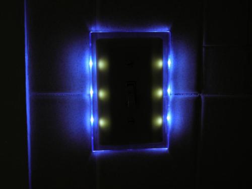 a mirror with blue lights in a dark room at Travelers Inn in Brunswick