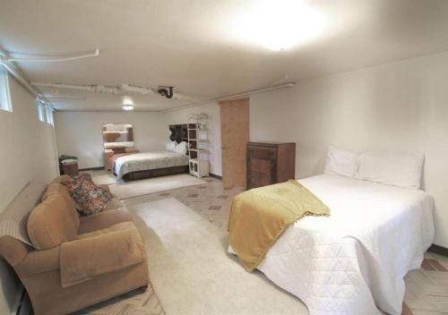 a bedroom with a large bed and a couch at Horsehead Haven in Monticello in Monticello