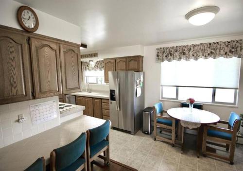 a kitchen with a table and a refrigerator at Horsehead Haven in Monticello in Monticello