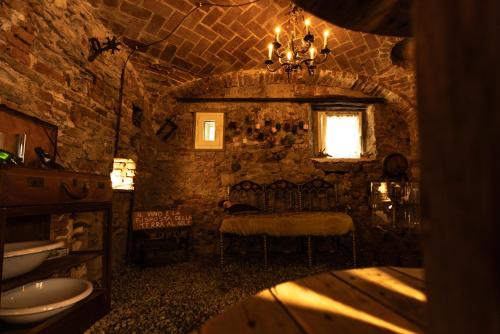 a stone bathroom with a sink and a window at Le calendule,relax home & wine in Strevi