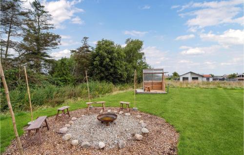 a fire pit in the middle of a yard at 3 Bedroom Awesome Home In Otterup in Hasmark