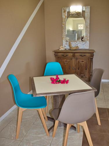 a dining room with a table and two chairs at Domaine Macabou in Le Vauclin