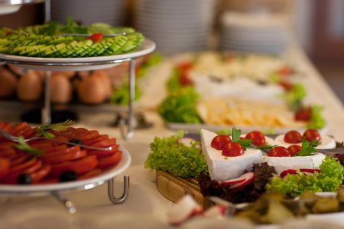 a table topped with different types of food on plates at Oasis Resort & Spa in Rewal