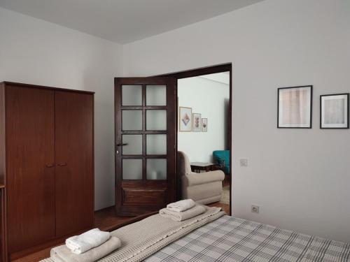 a bedroom with a bed with two towels on it at MILA city center-free parking in Vranje