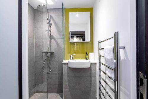 a bathroom with a sink and a shower at Charlotte Rise - Urban Apartments in Bristol
