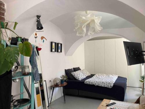 a living room with a bed in a room with an arch at Small Peace Oasis in Zagreb