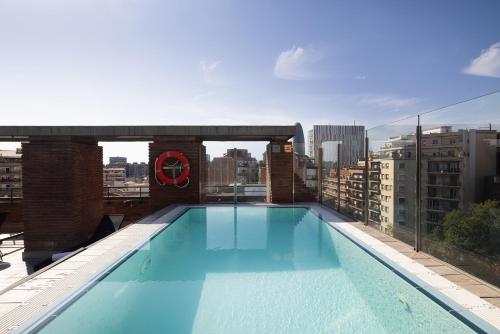 a swimming pool on the roof of a building at Catalonia Albeniz in Barcelona