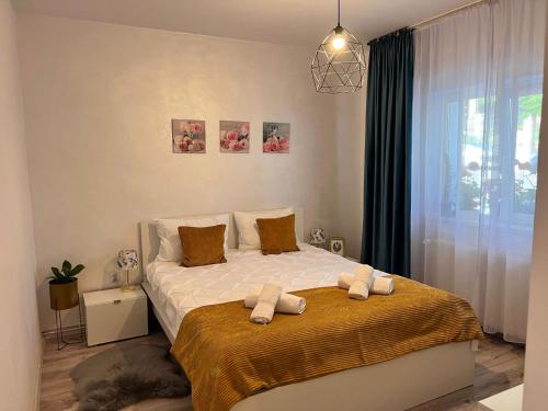 a bedroom with a bed with two towels on it at Sweet Home Apartament in Predeal