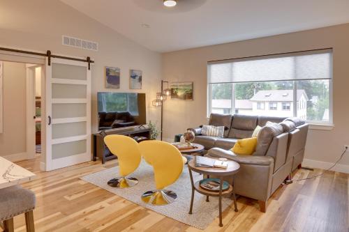 a living room with a couch and a table and chairs at Anchorage Apartment with a View about 3 Mi to Airport in Anchorage