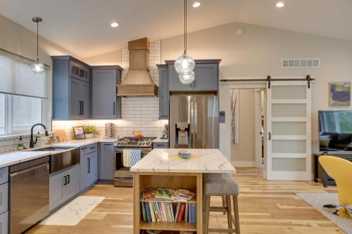 a kitchen with blue cabinets and a island in the middle at Anchorage Apartment with a View about 3 Mi to Airport in Anchorage