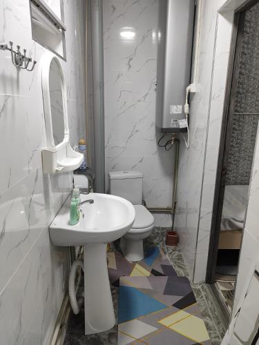 a bathroom with a sink and a toilet at Guest house SANAT in Naryn