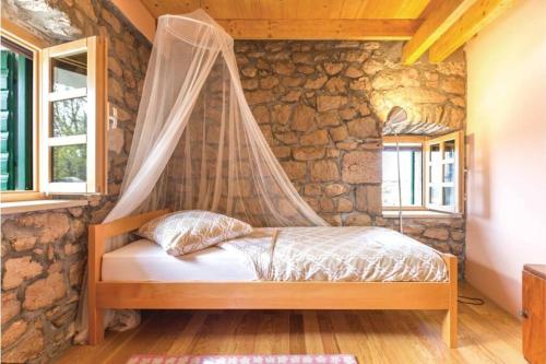 A bed or beds in a room at A stone house 'Pojata'