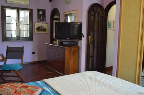 a bedroom with a bed and a television on a dresser at La Casa di Gianna in Sassari