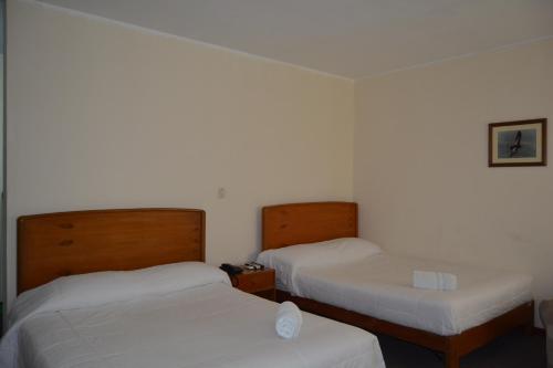 Ein Bett oder Betten in einem Zimmer der Unterkunft Hotel El Condor