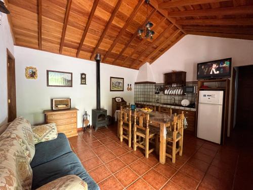 a living room with a table and a kitchen at Casa Los Calderos in Villa de Mazo