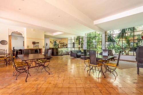 a large living room with tables and chairs in it at Riad le Ksar de Fes in Aïn Cheggag