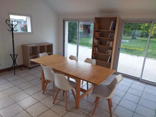 a dining room with a wooden table and chairs at Chez Marmotte in Creuzier-le-Neuf