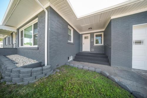 a house with a front porch with a door at Charming Erie Home about 2 Mi to Downtown Delights! in Erie