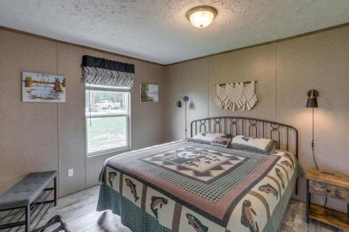 a bedroom with a bed and a table and a window at Rural Mt Olive Cabin Rental with White River View! in Melbourne