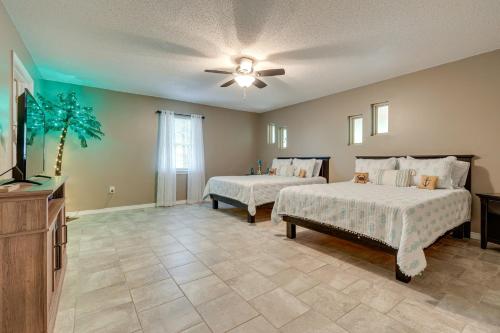 a bedroom with two beds and a ceiling fan at Peaceful Lucedale Hideaway on Private Acerage! in Lucedale