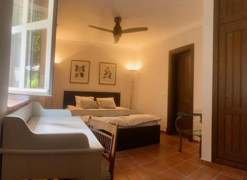 a bedroom with two beds and a ceiling fan at Casa Junto al Mar in La Herradura