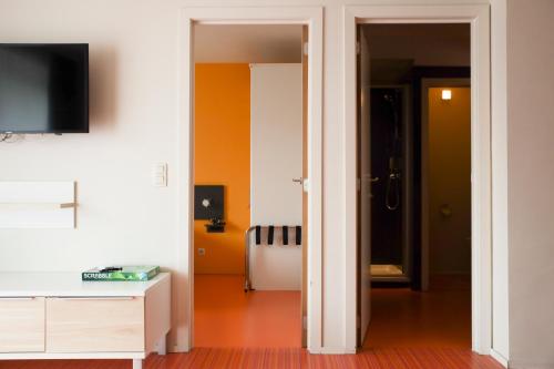 a room with a hallway with orange and white walls at Alfa Inn in Blankenberge
