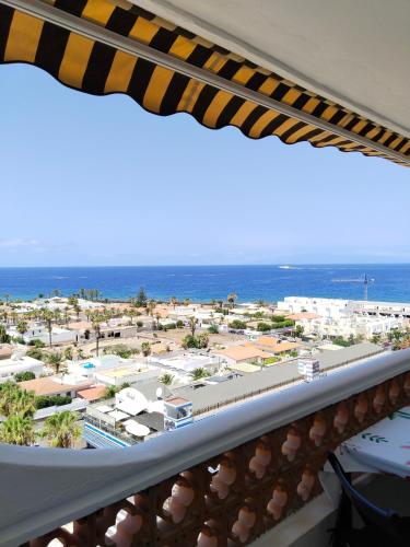 a view of the beach from the balcony of a resort at Palm-Mar Penthouse Celeste vue mer panoramique 200m de l'océan in Palm-Mar
