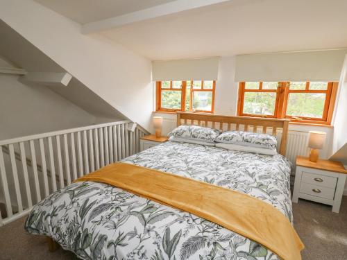 a bedroom with a large bed in a room at Rowan Cottage in Builth Wells